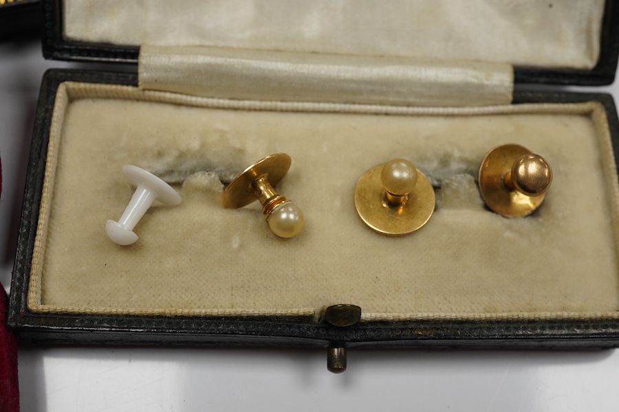 A cased pair of mid 20th century white metal and polychrome enamel oval cufflinks, by Benzies of Cowes, decorated with a pennant, together with five 9ct dress studs and a cased eight piece 9ct and enamel dress stud set.